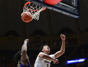 Tre Mitchell makes up for lost time, WVU rolls past Morehead State 75-57